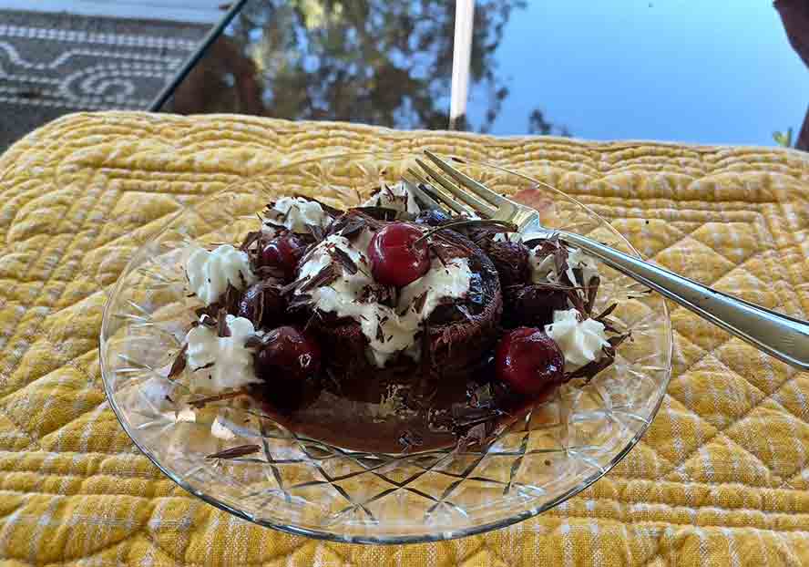 Top with cherries and whipped cream. 