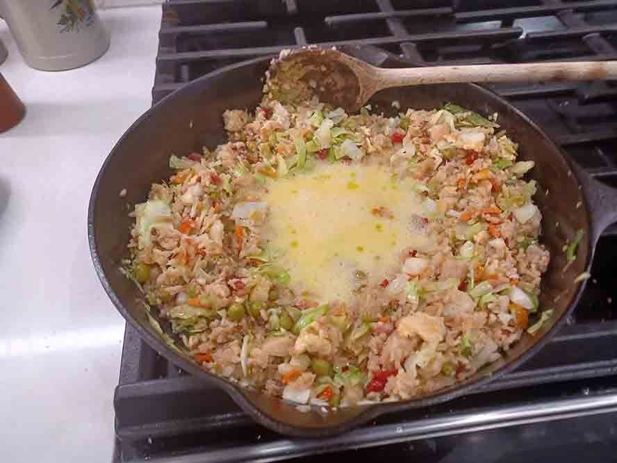 Cooking the eggs with the fried rice 